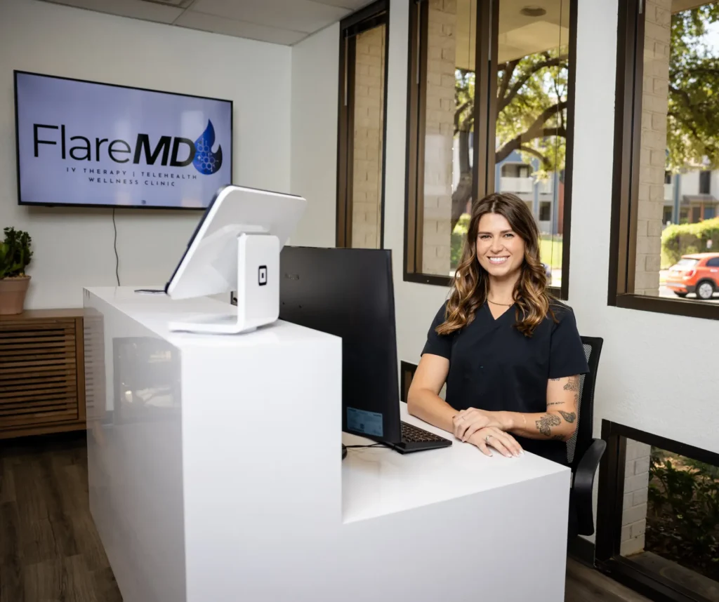 Female Nurse Sitting At Reception Desk